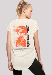 Cream short-sleeve t-shirt featuring a vibrant orange geisha graphic and text on the back, with a relaxed fit and rounded hem.