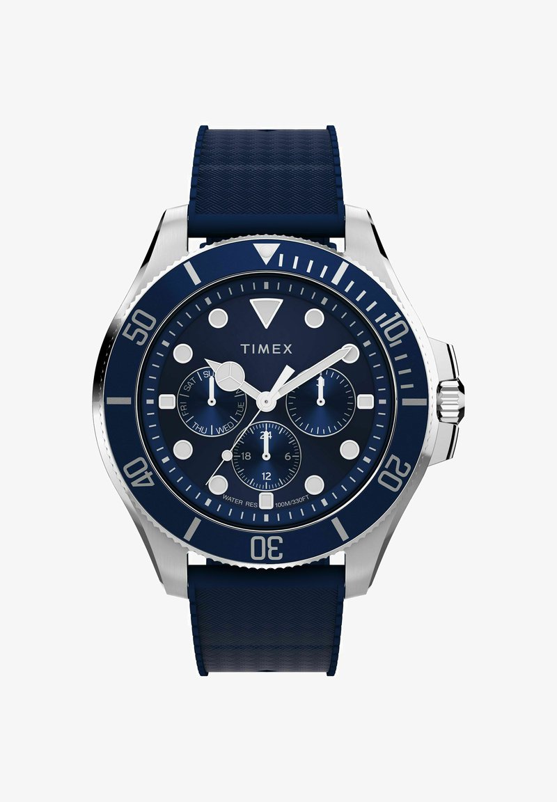 Blaues Timex-Armbanduhr mit silberner Lünette, drei Hilfszifferblättern für Tag, 24 Stunden und Stoppuhr sowie texturiertem blauem Silikonarmband.