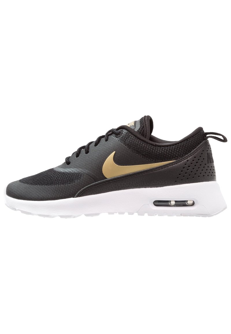 Black mesh and synthetic sneaker with gold Nike swoosh, white sole, rounded toe, and perforated back for breathability.