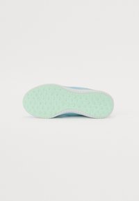Shoe sole in light mint green rubber with raised dots for traction, white rim, and smooth blue upper section. Simple, functional design.