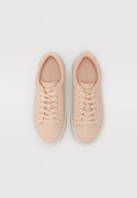 Light pink leather sneakers with a rounded toe, flat laces, and a translucent rubber sole. Brand logo embossed on the side.