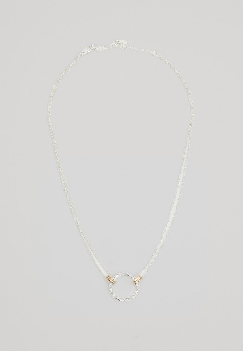Silver chain necklace with twisted metal circular accent, featuring two gold-colored hardware highlights near the pendant.