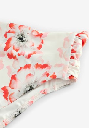 Floral swimsuit in soft white fabric featuring pink and red flower patterns, gathered edges, and smooth texture. Notable ruffled detail.