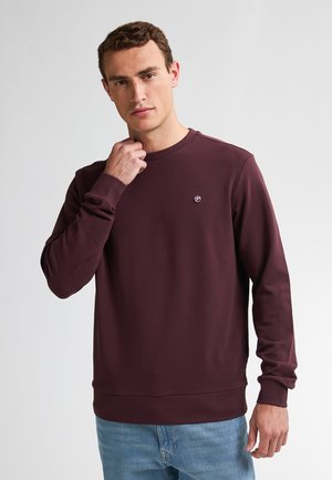 Wine-colored sweatshirt with a round neck, long sleeves, and ribbed cuffs. Features a small logo on the chest and a smooth, soft texture.
