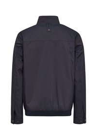 Navy jacket with vertical stripes, zip collar, and ribbed hem. Features snap-button cuffs and subtle branding detail at the back.