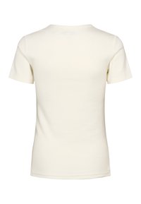 Papildoma atgalinė pusė paprasto šviesaus, trumpomis rankovėmis, riboto megztinio marškinėlių su apvalia apykakle ir siaura forma.