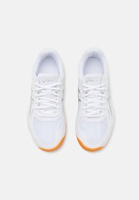 White athletic shoes with mesh and synthetic overlays, featuring grey accents and an orange rubber sole. Laced design with padded collar.