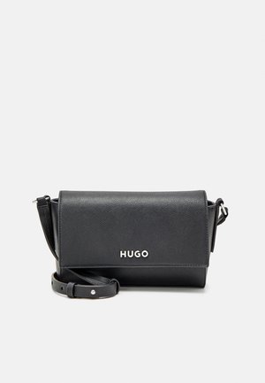 Black leather crossbody bag with adjustable strap and silver "HUGO" logo on front flap against a plain background.