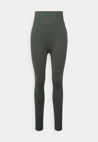 Wysokie legginsy w kolorze ciemnozielonym, wykonane z materiału o teksturze w deseń rybiej kratki. Dopasowany krój sięgający do kostek.