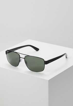 Occhiali da sole rettangolari neri con lenti verdi, montatura in metallo, poggiatunno in silicone e logo Ray-Ban distintivo sulla tempia.