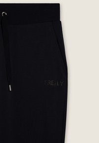 Pantaloni sportivi neri con cintura elastica, tasche laterali e logo "FREDDY" in strass. Realizzati in tessuto morbido e elasticizzato.