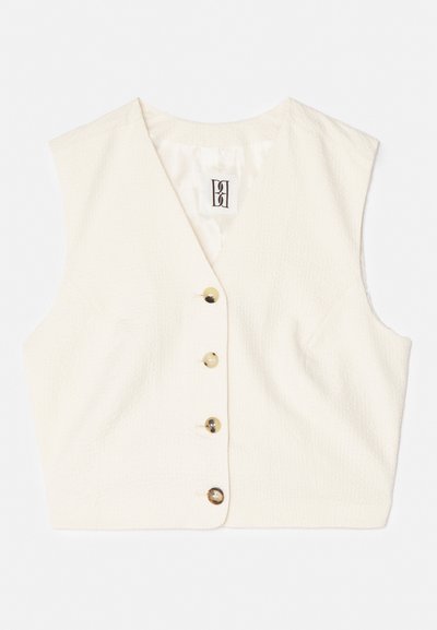 Gilet sans manches couleur crème avec un tissu texturé, décolleté en V et cinq boutons à l'avant de couleurs contrastées. Étiquette cousue à l'intérieur.