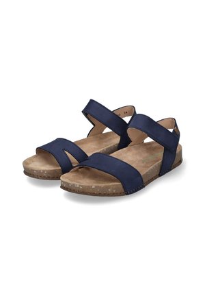 Navy blue sandals featuring two wide, crossed straps with a soft suede texture, a cushioned footbed, and a speckled, sturdy sole.