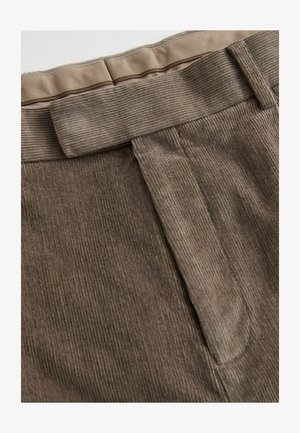 Brown corduroy fabric with vertical ridges, featuring a smooth waistband and a clean front design. Minimalist stitching and accents visible.