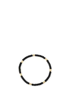 Braccialetto elastico con perline cilindriche nere alternate a piccole perline curve dorate su sfondo bianco.