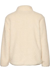 Krämfärgad fleecepullover med hög krage, texturerad yta och långa ärmar. Sömlös design med rundad nederkant.
