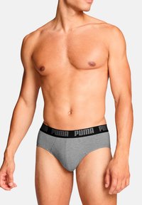 Graue Unterwäsche aus Baumwolle mit einem schwarzen, gebrandeten Bund. Das Design bietet eine enge Passform und nahtlose Kanten für zusätzlichen Komfort.