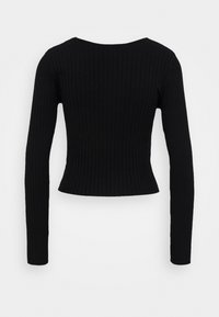 Haut noir en tricot côtelé à manches longues avec une taille légèrement évasée et un col rond, présenté de dos sur un fond uni.