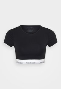 Svart avkortet t-skjorte laget av glatt stoff, med rund hals og korte ermer. Bunnbånd med "Calvin Klein"-logo i hvitt.