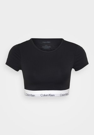Zwart cropped t-shirt van gladde stof, met een ronde halslijn en korte mouwen. Onderband met het "Calvin Klein" logo in het wit.