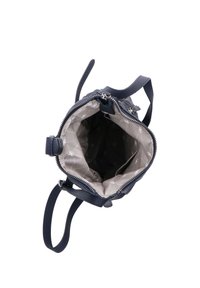 Pequeño bolso de mano azul marino con cremallera abierta que muestra un forro interior beige decorado con pequeños círculos y formas de flores.