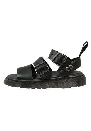 Sort lædersandal med to spænder, tyk sål og hælkappe, designet til afslappet brug.
