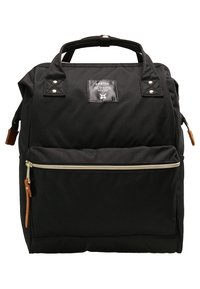 Sac à dos noir en tissu résistant, doté de deux poignées supérieures, d'une poche avant zippée et d'un patch avec logo. Accents en métal doré inclus.