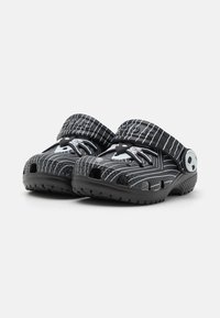 Black and grey clogs with a striped pattern, made of synthetic material. Features breathable holes and an adjustable strap.