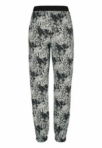 Black and white patterned joggers with an elastic waistband. Features a floral texture and cuffed hems for a fitted look at the ankles.