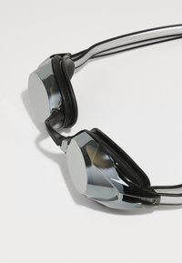 Sleek black and chrome headphones with rounded ear cups, flexible headband, and padded accents for comfort and sound isolation.