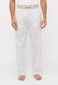 Witte pyjamabroek met verticale grijze strepen, elastische tailleband met het "Calvin Klein" logo, losse pasvorm, lichtgewicht stof, enkel lengte.