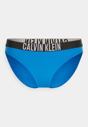 Vaaleansiniset bikinit, joissa on musta joustava vyötärö, jossa on valkoiset "CALVIN KLEIN" -logotekstit. Sileä kangas, normaali leikkaus.