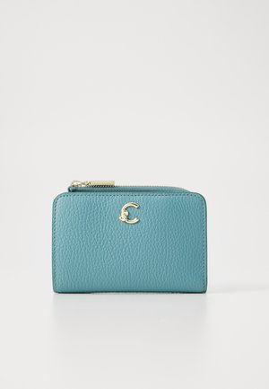 Teal leather wallet with a textured finish, featuring a gold logo accent and a zippered closure at the top. Compact rectangular design.