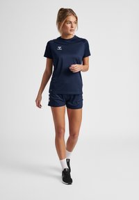 Navy athletic shirt with short sleeves and crew neck, paired with matching shorts. Features logo and contrasting accents on sides.