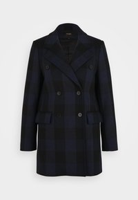 Manteau croisé en tartan bleu marine et noir. Il présente de grands revers, deux poches à rabat à l'avant et des boutons noirs. Coupe structurée et mélange de laine.