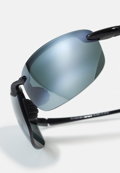 Black sunglasses with gradient blue lenses, curved shape, and rubber nose pads. Features sleek arms with a slight shine.