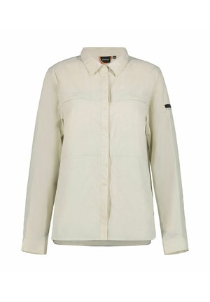 Camisa de color beige claro con botones, mangas largas, dos bolsillos en el pecho y una textura sutil. Presenta un logo de la marca en la manga izquierda.