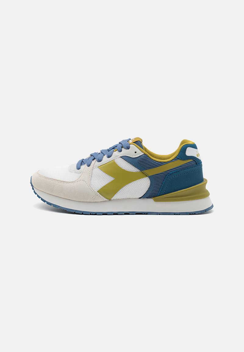 Sport shoes featuring a mesh upper in white and blue, with suede accents, a prominent yellow logo, and a textured rubber sole.