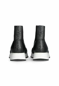 Stivali alla caviglia in pelle nera con una fascia elastica alta, caratterizzati da motivi di branding impressi e suole in gomma bianca. Finitura liscia con punta arrotondata.