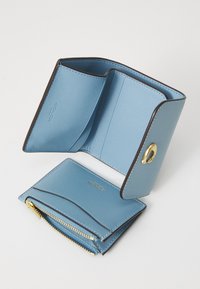 Light blue leather wallet with gold hardware, featuring multiple card slots, a zippered pocket, and a sleek design.