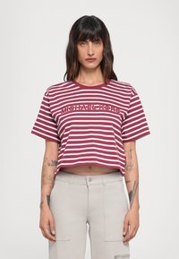 Korte mouw t-shirt met cropped snit in bordeauxrood en witte horizontale strepen, met een logo aan de voorkant in een contrasterende kleur. Glad katoenmateriaal.