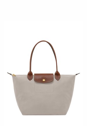 Gray tote bag with brown leather accents, featuring dual handles, a zip closure, and a pocket with a distinctive metal snap.