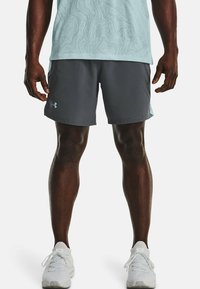 Gray athletic shorts with a smooth texture and side slits, paired with a light blue patterned top and white shoes.