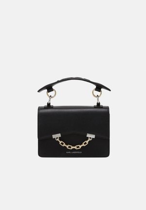Black structured handbag made of smooth leather featuring a short handle, chain detail, and minimalist silver hardware. Logo at the front.