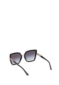 Ochelari de soare black oversized cu lentile gradient, accente metalice transparente roz și brațe subțiri negre cu logo-ul brandului.
