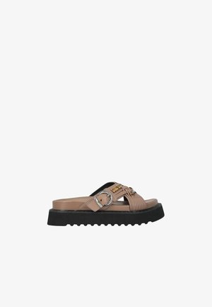 Sandalo a fascia beige con suola spessa rigata nera, fibbia argento sulla fascia laterale e dettaglio a catena color oro sulle fasce superiori.