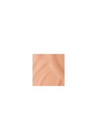 Creamy, textured liquid foundation in a warm peach tone, with slight sheen and visible droplet details on a smooth surface.