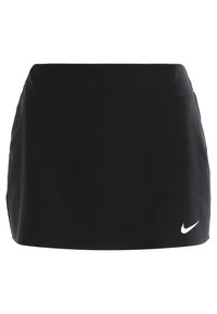 Falda de tenis negra de Nike con una silueta ajustada, textura suave y un acento del logo blanco en la parte inferior izquierda. Diseño simple y versátil.