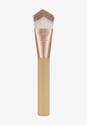 Makeup brush with angled, dense light bristles, rose gold ferrule engraved with "RT 139," and beige handle.