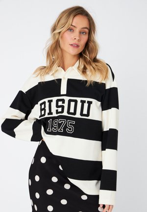 Long-sleeve polo shirt with black and white horizontal stripes. Features a collar, button closure, and "BISOU 1975" print. Soft fabric.